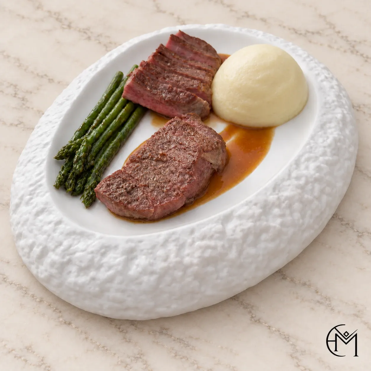Slices of seared steak with green asparagus, a quenelle of mashed potato and a dark jus on a textured white plate.