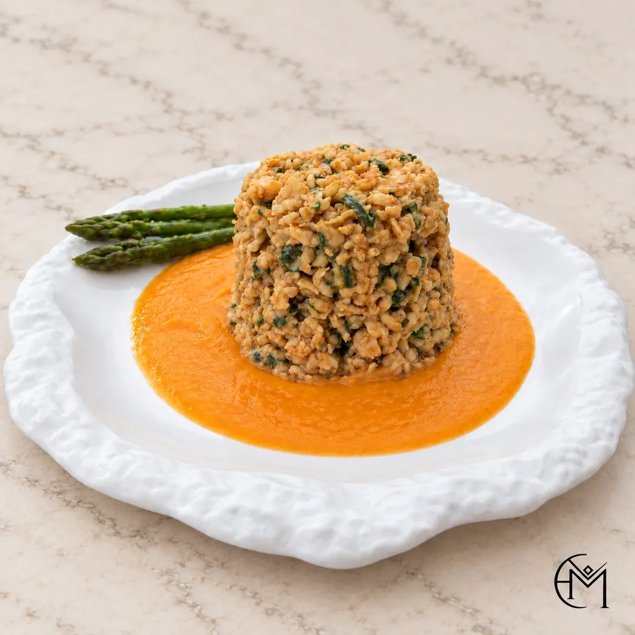 A moulded round of herbed grains on an orange sauce with green asparagus, on a textured white plate.